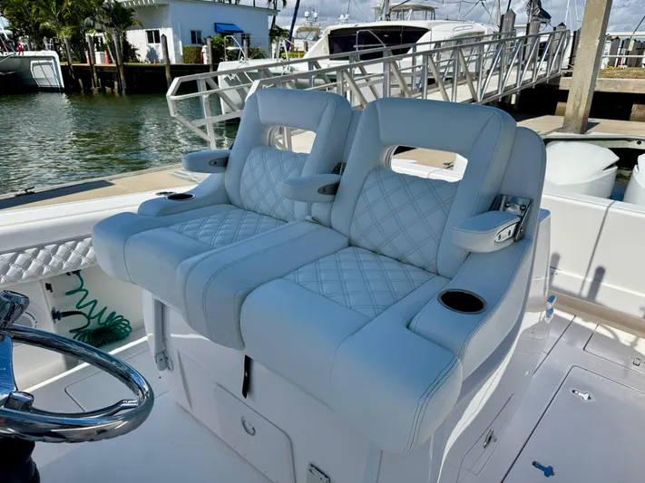  Yacht Photos Pics 2017 Intrepid 375 Center Console boat with luxurious seating at a marina.