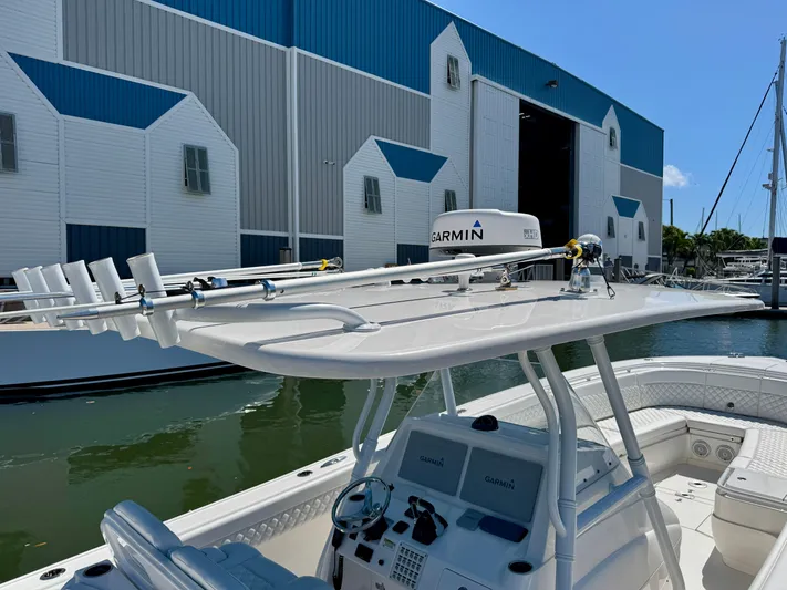  Yacht Photos Pics 2017 Intrepid 375 Center Console boat docked near a large blue and white building.