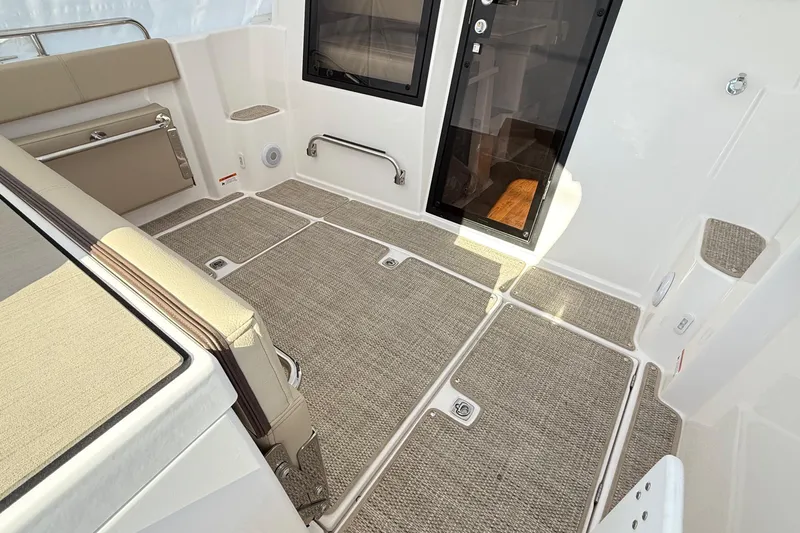  Yacht Photos Pics 2026 Cutwater C-248 Coupe interior with beige seating and carpeted flooring.
