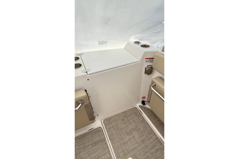  Yacht Photos Pics 2026 Cutwater C-248 Coupe interior with beige seating and storage compartment.