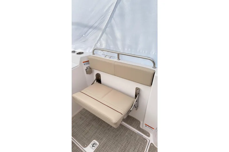  Yacht Photos Pics 2026 Cutwater C-248 Coupe interior with beige foldable seat and carpeted floor.