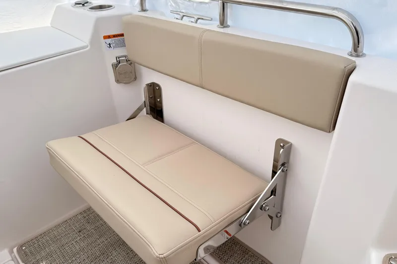 Yacht Photos Pics 2026 Cutwater C-248 Coupe boat seat with beige upholstery and stainless steel hardware.