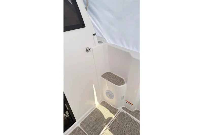  Yacht Photos Pics 2026 Cutwater C-248 Coupe interior with carpeted steps and white paneling.