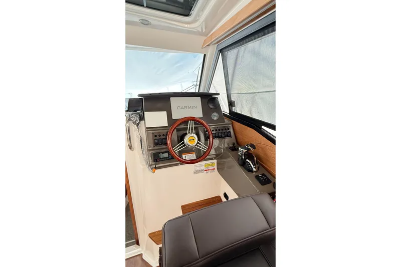  Yacht Photos Pics 2026 Cutwater C-248 Coupe helm with Garmin navigation, wood accents, and modern controls.