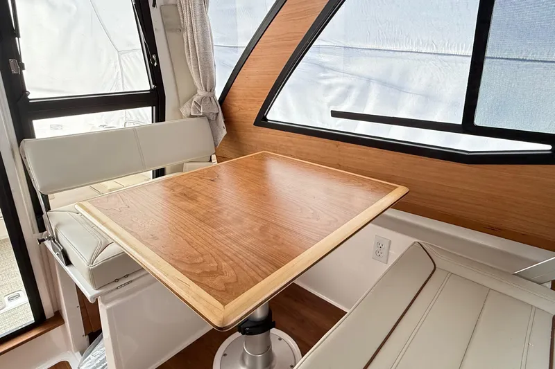  Yacht Photos Pics Interior of 2026 Cutwater C-248 Coupe featuring a wooden table and white seating.