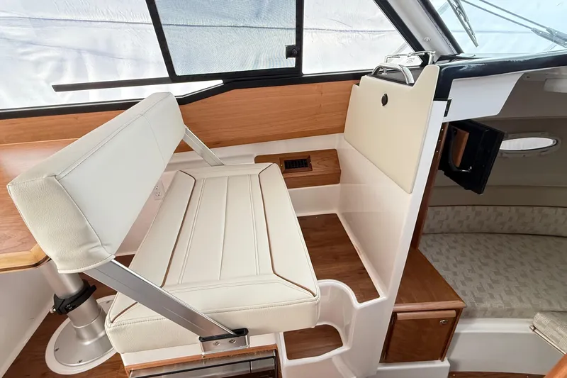  Yacht Photos Pics 2026 Cutwater C-248 Coupe interior with white seating and wood accents.