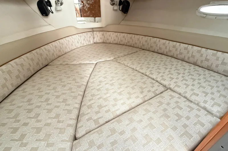  Yacht Photos Pics 2026 Cutwater C-248 Coupe interior cabin with patterned upholstery and cozy seating.