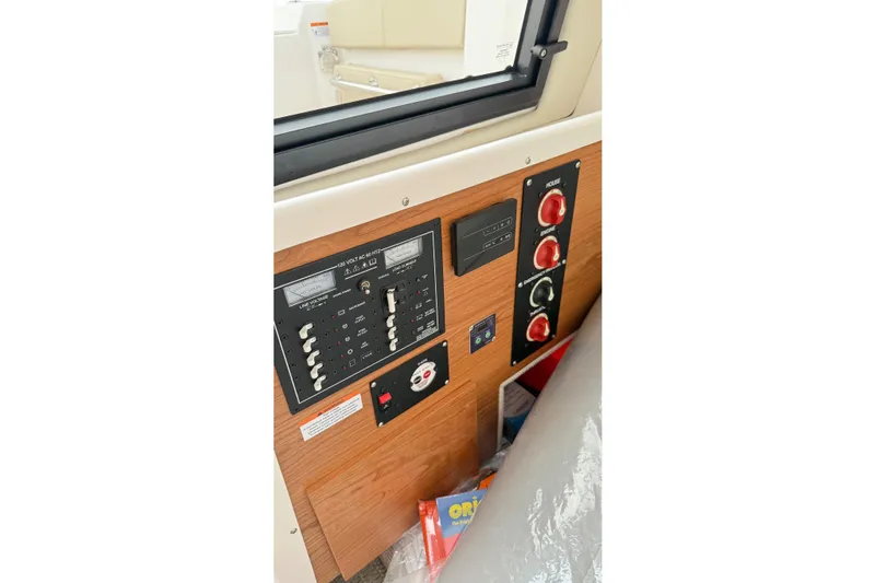  Yacht Photos Pics 2026 Cutwater C-248 Coupe control panel with switches and gauges, featuring a wood finish.