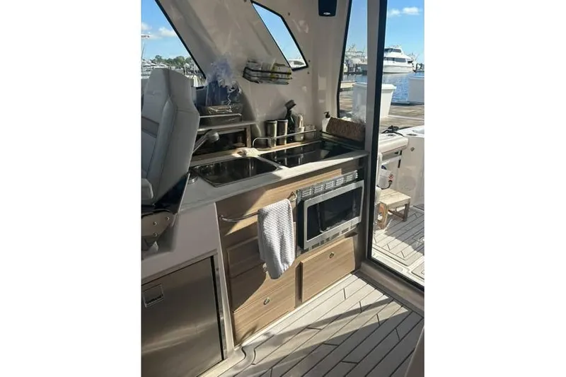 Venessa 1968 - Brokerage Kevin Yacht Photos Pics Modern kitchen area inside 2026 Solara S-310 SB yacht, featuring sink and microwave.