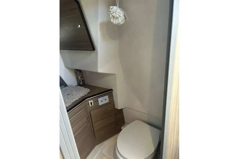 Venessa 1968 - Brokerage Kevin Yacht Photos Pics Compact bathroom in 2026 Solara S-310 SB boat with modern fixtures and wood cabinetry.