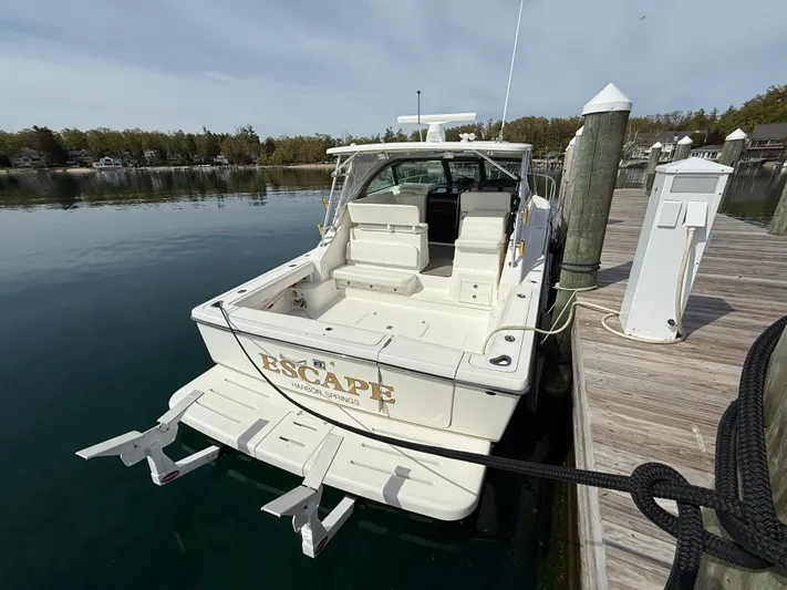  Yacht Photos Pics 2002 Pursuit 3800 Express boat docked at a marina, rear view.