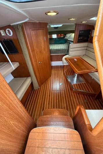  Yacht Photos Pics Interior of 2002 Pursuit 3800 Express boat with wood flooring and seating area.