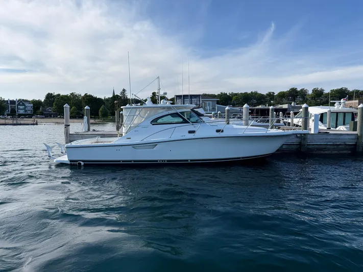  Yacht Photos Pics 2002 Pursuit 3800 Express yacht docked at a marina on a sunny day.