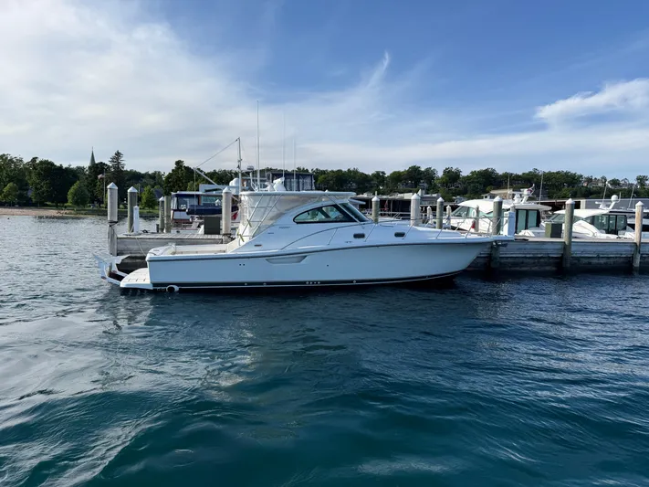  Yacht Photos Pics 2002 Pursuit 3800 Express yacht docked at a marina on a sunny day.