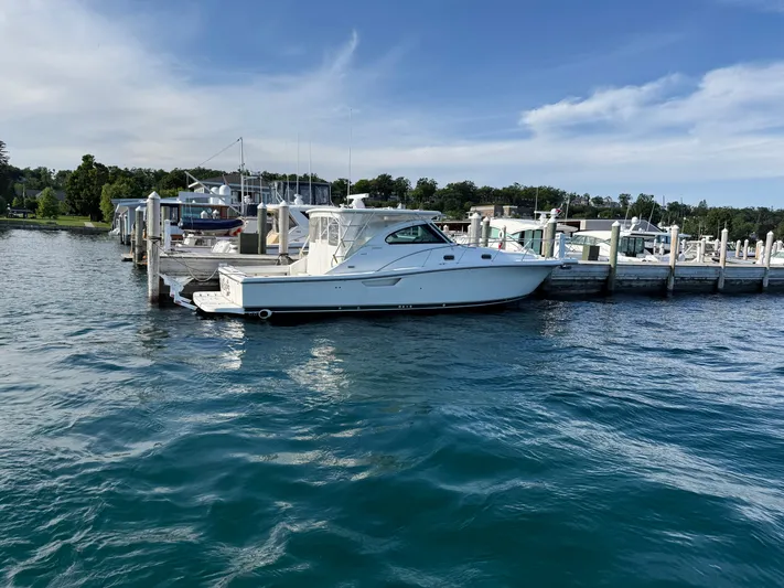  Yacht Photos Pics 2002 Pursuit 3800 Express yacht docked at marina on a sunny day.