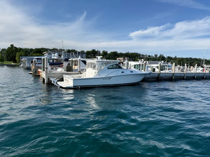  Yacht Photos Pics 2002 Pursuit 3800 Express yacht docked at a marina on a sunny day.