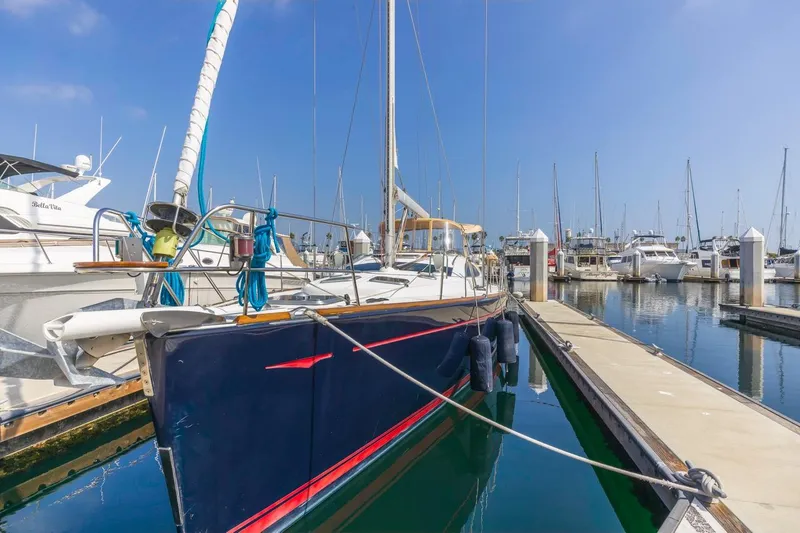 Maka Le'a Yacht Photos Pics 2006 Jeanneau DS sailboat docked in a marina under clear blue skies.