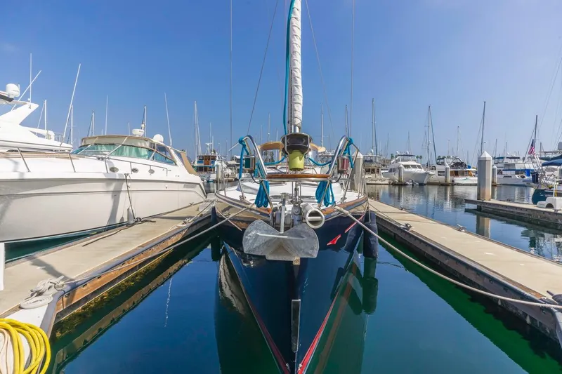 Maka Le'a Yacht Photos Pics 2006 Jeanneau DS sailboat docked in a marina, surrounded by other boats.