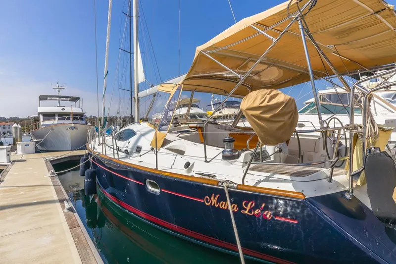 Maka Le'a Yacht Photos Pics 2006 Jeanneau DS sailboat docked at marina under clear blue sky.
