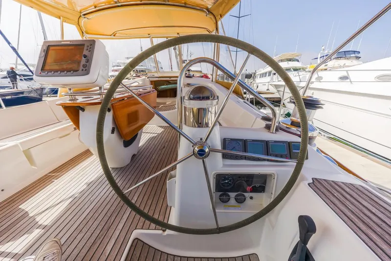 Maka Le'a Yacht Photos Pics Cockpit of 2006 Jeanneau DS sailboat with steering wheel and navigation equipment.