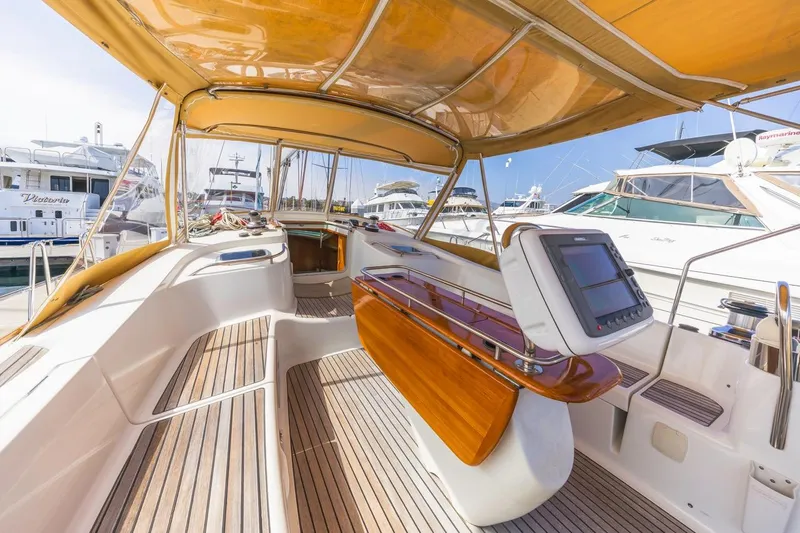 Maka Le'a Yacht Photos Pics 2006 Jeanneau DS yacht interior with wooden deck and navigation equipment.