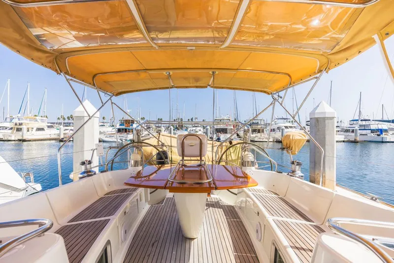 Maka Le'a Yacht Photos Pics 2006 Jeanneau DS yacht with spacious deck and canopy in marina setting.