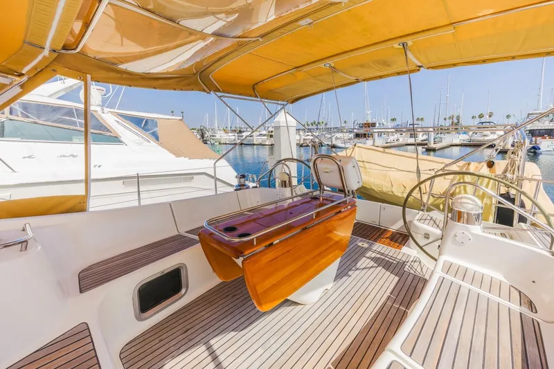Maka Le'a Yacht Photos Pics 2006 Jeanneau DS yacht cockpit with wooden accents and marina view.