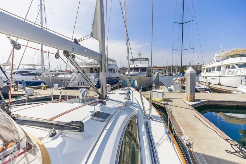 Maka Le'a Yacht Photos Pics 2006 Jeanneau DS sailboat docked at a marina, surrounded by other boats.