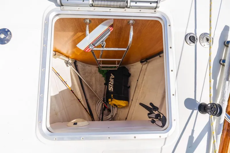 Maka Le'a Yacht Photos Pics Open hatch on 2006 Jeanneau DS sailboat showing storage with ladder and equipment.