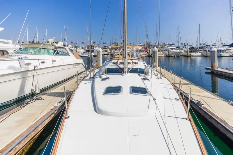 Maka Le'a Yacht Photos Pics 2006 Jeanneau DS sailboat docked in a marina under clear blue skies.