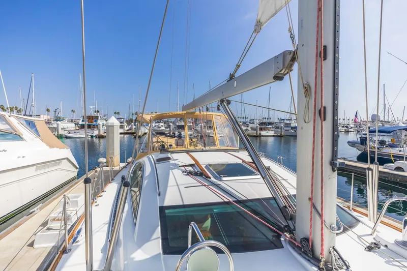 Maka Le'a Yacht Photos Pics 2006 Jeanneau DS sailboat docked in a marina under clear blue skies.