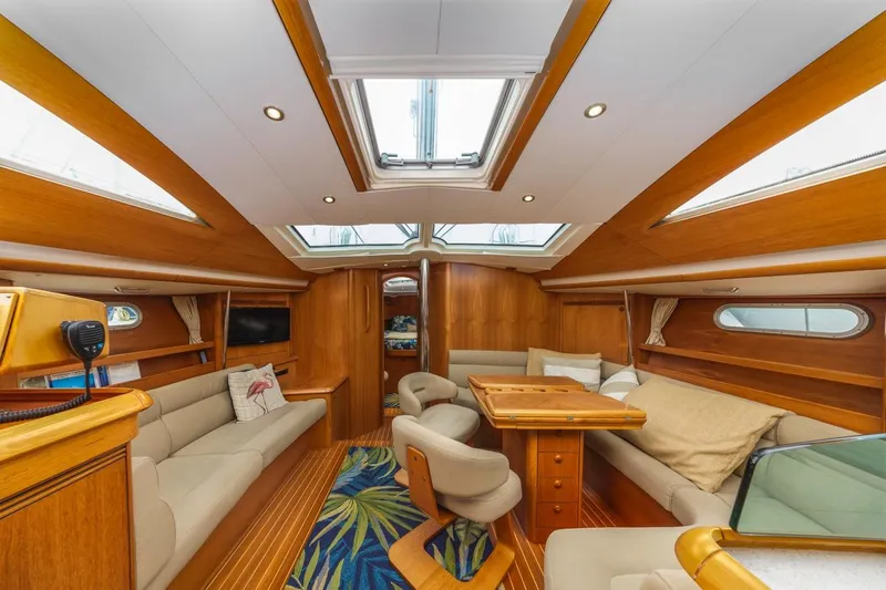 Maka Le'a Yacht Photos Pics Luxurious 2006 Jeanneau DS yacht interior with elegant wood finish and spacious seating area.