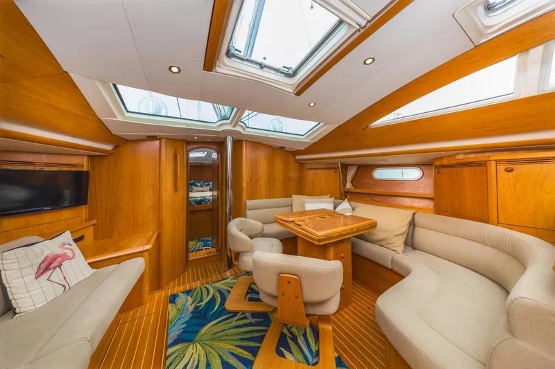 Maka Le'a Yacht Photos Pics Luxurious 2006 Jeanneau DS yacht interior with elegant wood finish and plush seating.
