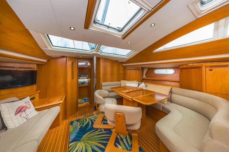 Maka Le'a Yacht Photos Pics Luxurious 2006 Jeanneau DS yacht interior with skylights, wood finish, and cozy seating area.