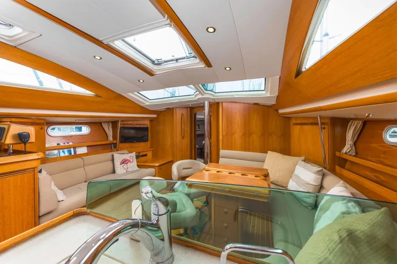 Maka Le'a Yacht Photos Pics Luxurious 2006 Jeanneau DS yacht interior with elegant wood finish and plush seating.