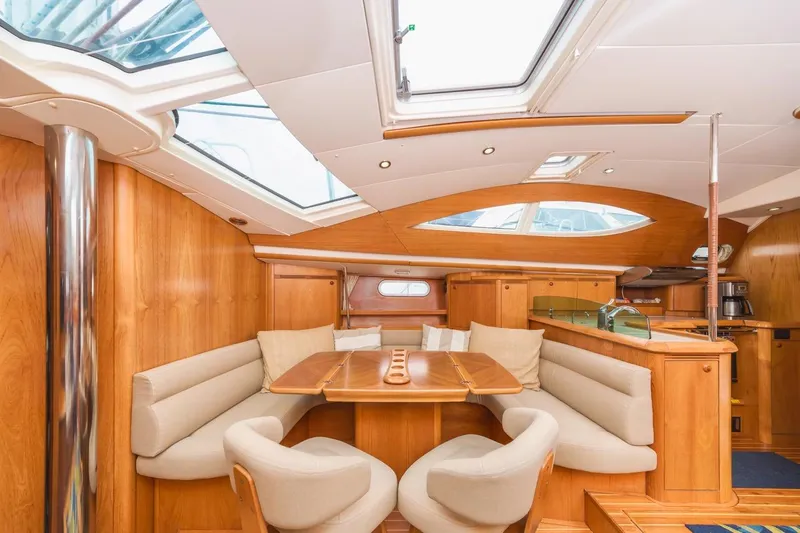 Maka Le'a Yacht Photos Pics Luxurious 2006 Jeanneau DS yacht interior with elegant wood finish and plush seating.