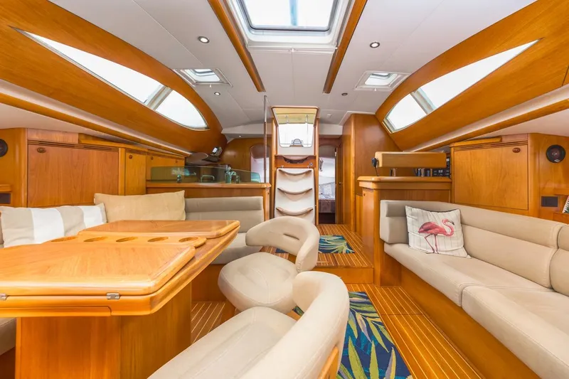 Maka Le'a Yacht Photos Pics Luxurious 2006 Jeanneau DS yacht interior with elegant wood finish and plush seating.