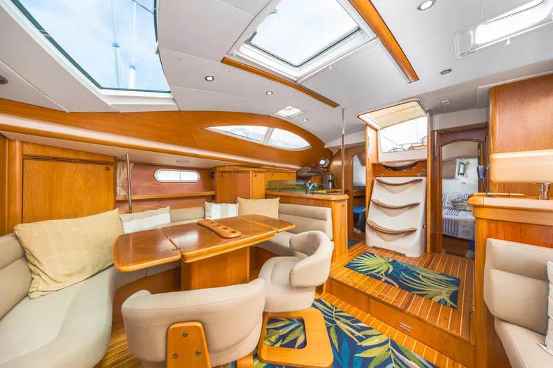 Maka Le'a Yacht Photos Pics Luxurious 2006 Jeanneau DS yacht interior with elegant wood finish and plush seating.