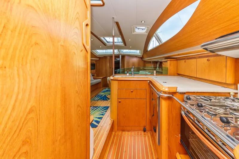 Maka Le'a Yacht Photos Pics Interior of 2006 Jeanneau DS yacht with wooden cabinetry and modern kitchen amenities.