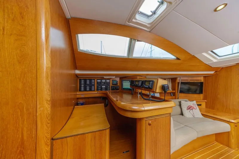 Maka Le'a Yacht Photos Pics 2006 Jeanneau DS yacht interior with wooden finish, navigation equipment, and skylights.