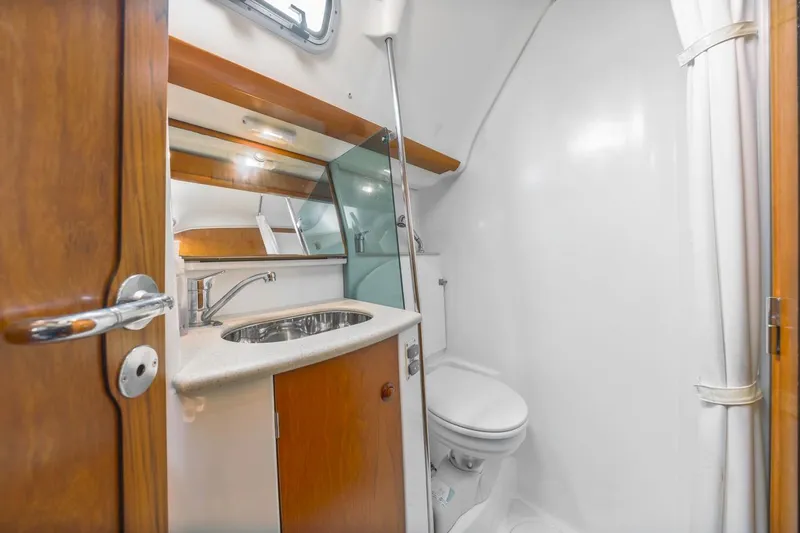 Maka Le'a Yacht Photos Pics 2006 Jeanneau DS yacht bathroom with sink, mirror, and toilet.