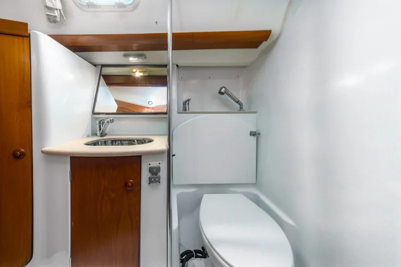 Maka Le'a Yacht Photos Pics 2006 Jeanneau DS yacht bathroom with sink, mirror, and toilet.
