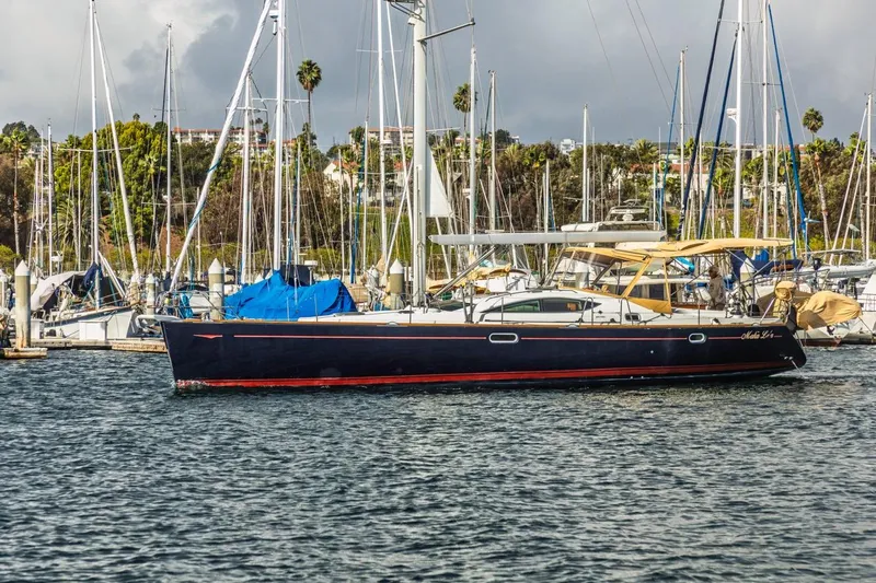 Maka Le'a Yacht Photos Pics 2006 Jeanneau DS sailboat docked in a marina with other boats.