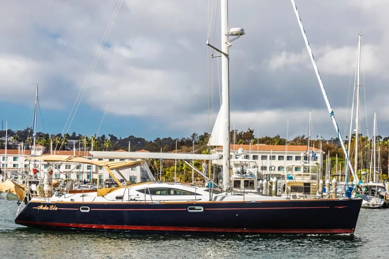 Maka Le'a Yacht Photos Pics 2006 Jeanneau DS sailboat docked in a marina with cloudy skies.