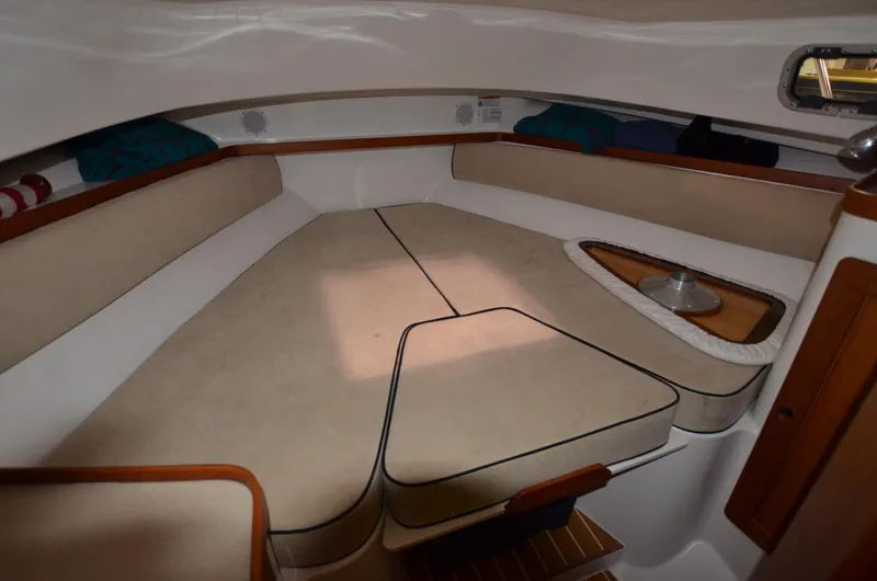 Able II Yacht Photos Pics 2008 Hunt Yachts Surfhunter 29 cabin interior with beige cushions and wooden accents.
