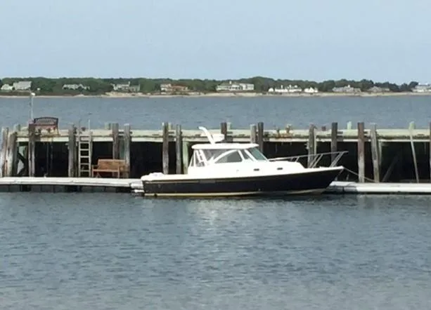 Able II Yacht Photos Pics 2008 Hunt Yachts Surfhunter 29 docked by a wooden pier.