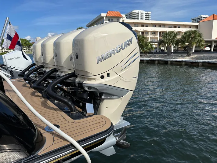  Yacht Photos Pics 2019 Scout 380 LXF with Mercury outboard engines docked by waterfront buildings.