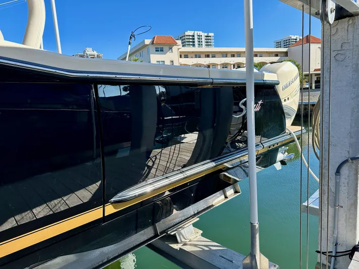  Yacht Photos Pics 2019 Scout 380 LXF boat docked, reflecting water and buildings.