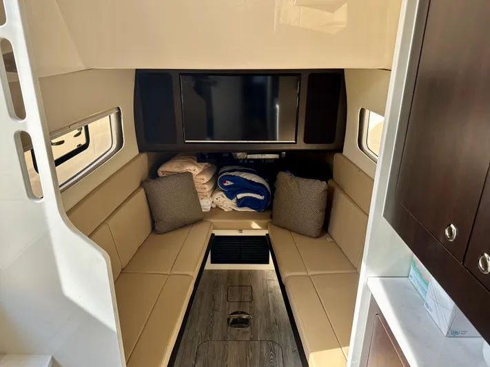  Yacht Photos Pics Luxurious interior of 2019 Scout 380 LXF boat with seating and TV.