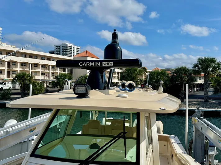  Yacht Photos Pics 2019 Scout 380 LXF boat with Garmin xHD2 radar, docked near waterfront buildings.